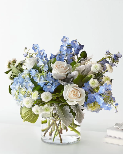 <p data-start="148" data-end="570">Bring calm and comfort into any moment with Clear Skies—a serene bouquet that captures the peaceful beauty of a cloudless day. With its soft blue blooms, classic white roses, and fresh greenery, this arrangement is perfect for sending support, love, or encouragement with quiet elegance. Whether you're celebrating new beginnings or offering sympathy during difficult times, Clear Skies delivers your sentiment with grace.</p>
<p data-start="572" data-end="1005">This soothing bouquet features delicate light blue flowers—such as hydrangea or delphinium—paired with crisp white roses and accented by a medley of fresh greens. The subtle interplay of color and texture creates a look that’s gentle and refreshing, like a breath of fresh air. Arranged in a clear glass vase, the bouquet feels clean and contemporary, allowing the natural beauty of each bloom to shine through with effortless style.</p>
<p data-start="1007" data-end="1413">Clear Skies is a versatile choice for many occasions. It’s ideal for get-well wishes, sympathy gestures, new baby celebrations, or simply letting someone know you’re thinking of them. The palette of whites, blues, and greens conveys calm and clarity, making it especially comforting in times of reflection or transition. It’s also a beautiful addition to home décor, adding a peaceful presence to any room.</p>
<p data-start="1415" data-end="1803">Every bouquet is thoughtfully arranged and hand-delivered by a skilled local florist, ensuring fresh, high-quality flowers and a stunning presentation every time. Rosa’s La Hacienda proudly serves the Boca Raton area with care, creativity, and exceptional floral design. When you send Clear Skies, you’re sending more than flowers—you’re delivering a meaningful message wrapped in beauty.</p>
<p data-start="1805" data-end="1932" data-is-last-node="" data-is-only-node="">Send a moment of peace and a gentle reminder of brighter days ahead with Clear Skies—a bouquet as calming as a perfect morning.</p>
