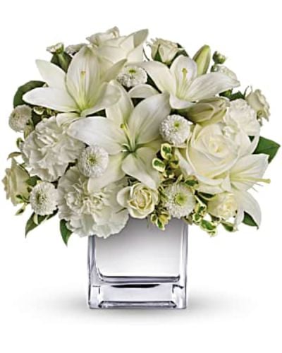 <p data-start="118" data-end="396">Simple, graceful, and full of meaning, Peace & Joy is a striking all-white bouquet that brings calm, beauty, and a quiet sense of celebration to any occasion. Though compact in size, its elegant design leaves a lasting impression.</p>
<p data-start="398" data-end="695">This arrangement features a stunning mix of white roses, spray roses, Asiatic lilies, carnations, and button spray chrysanthemums. Accented with fresh greenery and presented in a mirrored silver cube vase, the bouquet offers a modern, luminous touch that enhances its clean and peaceful aesthetic.</p>
<p data-start="697" data-end="952">Peace & Joy is an ideal gift for holiday gatherings, sympathy gestures, anniversaries, or as a sophisticated expression of love and thoughtfulness. Its soft color palette and gentle floral selection make it perfect for both festive and reflective moments.</p>
<p data-start="954" data-end="1256">Every bouquet is handcrafted by the florists at Rosa’s La Hacienda, your trusted local flower shop in Boca Raton. We provide same-day flower delivery throughout Boca Raton and the surrounding communities, ensuring that your gift arrives fresh and beautifully arranged with care and attention to detail.</p>
<p data-start="1258" data-end="1494">Want to personalize your delivery? Add a thoughtful message during checkout to make your gift even more meaningful. With Peace & Joy, you’re sending more than flowers—you’re sending a gesture of elegance, hope, and heartfelt connection.</p>
<p data-start="1496" data-end="1587">Order today from Rosa’s La Hacienda and share a moment of peace and beauty through flowers.</p>