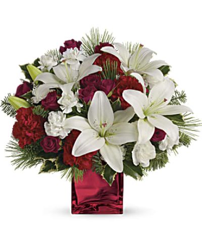 <p data-start="178" data-end="444">Capture the warmth and joy of the season with <em data-start="224" data-end="246">Caroling In The Snow</em>, a charming holiday bouquet that sings with classic beauty. Inspired by the nostalgic spirit of winter nights and festive gatherings, this delightful arrangement is a heartfelt way to spread cheer.</p>
<p data-start="446" data-end="800">This festive design features rich red spray roses and pristine white Asiatic lilies, creating a timeless color harmony of red and white that mirrors the heart of the holiday season. The blooms are artfully arranged inside a red mirrored cube vase that sparkles like fresh snow under twinkling lights, adding just the right amount of glamour to your gift.</p>
<p data-start="802" data-end="1160">With each flower placed to perfection, the bouquet evokes the coziness of carolers bundled in scarves and mittens, singing beneath a snowy sky. The fragrant lilies offer a touch of elegance, while the red spray roses add classic Christmas warmth. Together, they form a balanced and beautiful centerpiece or holiday gift suitable for any seasonal celebration.</p>
<p data-start="1162" data-end="1472">Ideal for sending warm wishes to loved ones, surprising a holiday host, or brightening your own space, <em data-start="1265" data-end="1287">Caroling In The Snow</em> is perfect for Christmas dinners, December birthdays, and winter “thinking of you” moments. It also makes a lovely gift for coworkers or clients who appreciate tasteful seasonal décor.</p>
<p data-start="1474" data-end="1865">Every bouquet is hand-crafted by Rosa’s La Hacienda, your trusted local florist in Boca Raton, Florida. We carefully select the freshest blooms and arrange them with expert care to ensure your gift arrives as pictured—full of beauty and holiday spirit. Due to local availability, flower varieties and accents may vary slightly, but the overall festive look and feel will always be preserved.</p>
<p data-start="1867" data-end="2043">Celebrate the season with a joyful arrangement that’s as memorable as a favorite carol. <em data-start="1955" data-end="1977">Caroling In The Snow</em> is the perfect way to bring holiday magic into any home or heart.</p>