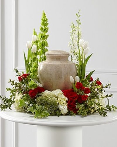 <p data-start="177" data-end="617">Express the deepest sympathy with The FTD® Tears of Comfort™ Arrangement, an elegant floral tribute designed to surround an urn with warmth, beauty, and grace. With its lush blend of classic reds, pure whites, and vibrant greens, this arrangement offers comfort during life’s most difficult moments while honoring the legacy of someone dearly missed.</p>
<p data-start="619" data-end="1100">This exquisite sympathy piece features a rich variety of premium blooms, including vivid red roses and red spray roses for heartfelt emotion, paired with the quiet purity of white tulips and hydrangea. White larkspur and trachelium add height and airiness, while the bright green Bells of Ireland bring movement and a symbolic message of renewal. Accents of hypericum berries, ivy, and myrtle provide depth and natural elegance, completing a design that both comforts and inspires.</p>
<p data-start="1102" data-end="1406">Carefully designed to encircle an urn or framed photo, this arrangement creates a serene and beautiful focal point at a memorial service or celebration of life. The combination of colors and textures evokes memories, love, and spiritual peace, helping to support and uplift those gathered in remembrance.</p>
<p data-start="1408" data-end="1836">At Rosa’s La Hacienda in Boca Raton, every sympathy arrangement is crafted with compassion and care. Our local florists are honored to help families through difficult times by offering fresh, respectful floral designs delivered promptly and professionally. We provide same-day service throughout Boca Raton and the surrounding area, including direct coordination with funeral homes or service venues to ensure seamless delivery.</p>
<p data-start="1838" data-end="2122">You may also add a personalized message during checkout to accompany this tribute and offer words of comfort to grieving family and friends. The FTD® Tears of Comfort™ Arrangement is more than a floral display—it is a meaningful expression of love, remembrance, and heartfelt support.</p>
<p data-start="2124" data-end="2236">Place your order today with Rosa’s La Hacienda and let us help you honor a beautiful life with dignity and care.</p>