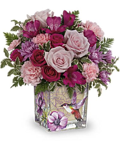 <p data-start="195" data-end="515">The <em data-start="199" data-end="218">Sweet Hummingbird</em> bouquet captures the wonder of a garden in bloom, with flowers so light and lovely they seem to hover in midair. This enchanting arrangement brings the gentle beauty of nature indoors, making it a heartfelt gift for Mother's Day, birthdays, or any moment that calls for celebration and affection.</p>
<p data-start="517" data-end="946">This floral design unfolds like a hidden garden touched by spring sunshine. Hot pink spray roses add vibrance, while rich pink alstroemeria and soft pink carnations create softness and warmth. Lavender cushion chrysanthemums introduce a hint of calm, and delicate miniature pink blooms add intricate texture. Accented with lush greenery like leatherleaf fern and pitta negra, the bouquet feels airy, graceful, and alive with joy.</p>
<p data-start="948" data-end="1303">Arranged in a charming, vintage-style glass cube vase, this bouquet adds a touch of timeless elegance to any space. The compact and stylish design makes it perfect for desks, coffee tables, bedside stands, or kitchen counters—anywhere that could use a little bloom of happiness. It’s a gift that doesn’t overwhelm but always makes a meaningful impression.</p>
<p data-start="1305" data-end="1673">The <em data-start="1309" data-end="1328">Sweet Hummingbird</em> bouquet is perfect for honoring mothers, delighting friends, or surprising someone special “just because.” Its vibrant yet gentle palette symbolizes appreciation, tenderness, and beauty in motion—just like the tiny bird it’s named after. Whether you’re celebrating love, family, or friendship, this arrangement delivers your message with grace.</p>
<p data-start="1675" data-end="1950">Expertly arranged and hand-delivered by Rosa’s La Hacienda in Boca Raton, Florida, this bouquet is always crafted with care and seasonal freshness. We offer local delivery for every occasion, making it easy to send thoughtful surprises straight from your heart to their door.</p>
<p data-start="1952" data-end="2092">Let the <em data-start="1960" data-end="1979">Sweet Hummingbird</em> bouquet flutter into someone’s life with charm and color. It’s a moment of joy, beautifully captured in flowers.</p>