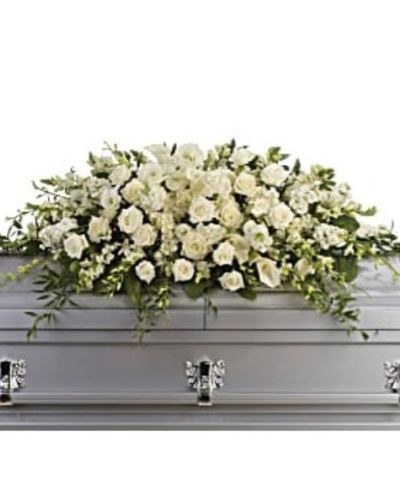 <div id="mark-1" class="m-pdp-tabs-marketing-description">
<p data-start="75" data-end="395">Honor the life of a loved one with <em data-start="110" data-end="138">Teleflora’s Purity & Peace</em>, an all-white casket spray that radiates tranquility, reverence, and timeless beauty. Designed for a full couch or closed casket service, this large-scale arrangement offers a graceful expression of remembrance through some of nature’s most elegant blooms.</p>
<p data-start="397" data-end="803">This lush tribute features an exquisite combination of white roses, dendrobium orchids, large calla lilies, and full white hydrangea. Each flower is chosen for its purity and symbolic meaning—roses for love, orchids for respect, calla lilies for renewal, and hydrangea for heartfelt emotion. The soft textures and clean color palette create a peaceful presence, bringing a sense of calm to a solemn moment.</p>
<p data-start="805" data-end="1049"><em data-start="805" data-end="821">Purity & Peace</em> is a fitting farewell for a life marked by grace, kindness, and quiet strength. Its gentle beauty provides comfort to family and friends while serving as a meaningful tribute to someone whose legacy lives on in love and memory.</p>
<p data-start="1051" data-end="1399">Handcrafted with care by the floral artisans at Rosa’s La Hacienda in Boca Raton, every detail of this arrangement is thoughtfully arranged to reflect dignity and compassion. We offer same-day delivery to funeral homes and memorial venues throughout Boca Raton and surrounding communities, ensuring your tribute arrives fresh, elegant, and on time.</p>
<p data-start="1401" data-end="1612">Add a personal message at checkout to share your thoughts and support. At Rosa’s La Hacienda, we are honored to help you commemorate life’s most tender moments with floral arrangements that speak from the heart.</p>
<p data-start="1614" data-end="1774" data-is-last-node="" data-is-only-node="">Order today for same-day delivery in Boca Raton and nearby areas. <em data-start="1680" data-end="1708">Teleflora’s Purity & Peace</em> is a serene and powerful way to say farewell with love and grace.</p>
</div>