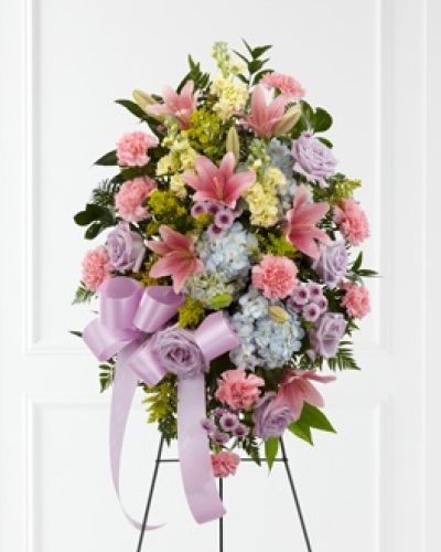<p data-start="132" data-end="544">Offer a gentle and serene tribute to a cherished life with the <em data-start="260" data-end="296">FTD® Blessings of the Earth™ Easel</em>. This standing spray evokes the beauty of nature and the warmth of remembrance, blending soft pastels and rich textures in a truly heartfelt floral display. It's a graceful way to express your sympathy while honoring the memory of someone special.</p>
<p data-start="546" data-end="937">The arrangement features a peaceful mix of lavender roses, pink carnations, pink Asiatic lilies, yellow stock, blue hydrangea, lavender button poms, solidago, and seasonal greenery. Each stem is thoughtfully arranged to reflect the tender balance of joy and sorrow that accompanies a final goodbye. A lavender satin ribbon adds an elegant touch, completing this beautiful easel presentation.</p>
<p data-start="939" data-end="1361">Ideal for funerals, memorials, or celebration of life services, this floral spray serves as a comforting presence at the front of the room. Its soft colors and natural design make it well-suited for remembering a loved one who brought calm, kindness, and light to others. Whether you are honoring a close friend or a beloved relative, the <em data-start="1278" data-end="1309">Blessings of the Earth™ Easel</em> makes your sentiments known with grace and dignity.</p>
<p data-start="1363" data-end="1717">Expertly handcrafted by Rosa’s La Hacienda in Boca Raton, each easel is designed with care using only the freshest blooms available. We offer local delivery to funeral homes, churches, and residences throughout the Boca Raton area. Our team handles every order with sensitivity, ensuring that your floral tribute arrives on time and in perfect condition.</p>
<p data-start="1719" data-end="1993">For those seeking a refined, meaningful expression of sympathy, the <em data-start="1787" data-end="1818">Blessings of the Earth™ Easel</em> offers a fitting tribute to a life filled with beauty, love, and gentle impact. It speaks from the heart and brings a quiet sense of comfort to those gathered in remembrance.</p>