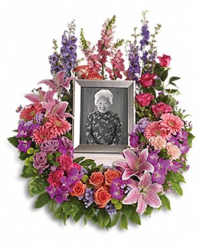 <div class="m-pdp-tabs-description">
<div id="mark-1" class="m-pdp-tabs-marketing-description">
<p data-start="165" data-end="399">Honor a cherished life with a wreath that beautifully expresses devotion and lasting memories. The <em data-start="264" data-end="281">Memorial Wreath</em> is a softly elegant tribute designed to convey your affection, respect, and heartfelt sympathy during a time of loss.</p>
<p data-start="401" data-end="718">This dramatic arrangement features a rich mix of blooms including purple orchids, asters, orange, dark pink, and lavender roses, as well as pink and peach carnations. Accents of lavender larkspur, green chrysanthemums, oriental lilies, gerberas, snapdragons, and other seasonal flowers create a lush, vibrant display.</p>
<p data-start="720" data-end="983">Ideal for funerals, memorial services, or to send as a thoughtful sympathy gift, this wreath serves as a loving reminder of the bond shared and memories treasured. Please note, this arrangement does not include a picture frame and is intended as a floral tribute.</p>
<p data-start="985" data-end="1248">Each <em data-start="990" data-end="1007">Memorial Wreath</em> is handcrafted by the skilled florists at Rosa’s La Hacienda, your trusted local florist in Boca Raton. We provide same-day delivery throughout Boca Raton and nearby communities, ensuring your tribute arrives fresh and beautifully arranged.</p>
<p data-start="1250" data-end="1408">Add a personal message at checkout to accompany your gift. With the <em data-start="1318" data-end="1335">Memorial Wreath</em>, you send a lasting symbol of love, remembrance, and sincere compassion.</p>
</div>
</div>