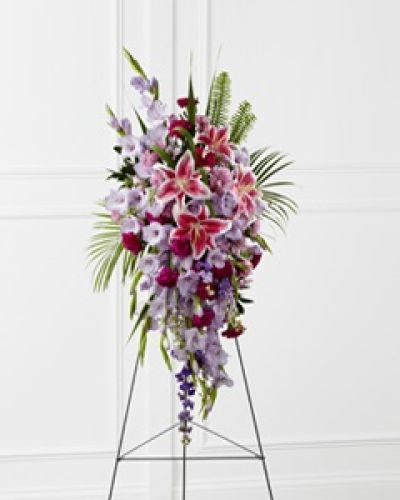 <p data-start="169" data-end="554">When the occasion calls for elegance, reverence, and beauty, The FTD® Tender Touch™ Standing Spray delivers a moving tribute filled with love and light. This graceful floral display is designed to honor a life lived with gentleness, strength, and a vibrant spirit that touched all who knew them.</p>
<p data-start="556" data-end="972">A stunning medley of soft purples, radiant pinks, and soothing greens creates a harmonious blend of color. Featuring lavender gladiolus, fuchsia carnations, stargazer lilies, purple larkspur, Peruvian lilies, and lavender chrysanthemums, every bloom adds its own expression of sympathy, admiration, and remembrance. Sword fern and emerald palm fronds add depth and structure, giving this spray a lush, full presence.</p>
<p data-start="974" data-end="1357">Presented on a sturdy wire easel, the standing spray offers a vertical tribute that stands with quiet dignity beside the casket or memorial. Its vertical design allows it to be seen from across the room, offering comfort to grieving families and serving as a lasting symbol of beauty during a time of sorrow. The fragrance of the lilies adds a subtle note of serenity to the setting.</p>
<p data-start="1359" data-end="1729">Rosa’s La Hacienda in Boca Raton is proud to provide this heartfelt sympathy arrangement with the care and detail your loved one deserves. We offer same-day local delivery and coordinate directly with funeral homes across the Boca Raton area to ensure your flowers arrive fresh and flawlessly arranged. Our team treats every sympathy order with compassion and precision.</p>
<p data-start="1731" data-end="1977">The FTD® Tender Touch™ Standing Spray is an ideal choice for expressing condolences when words feel insufficient. Whether from family, friends, or coworkers, this arrangement speaks to the tenderness of memory and the beauty of a life well lived.</p>
<p data-start="1979" data-end="2107">Order now from Rosa’s La Hacienda and allow us to help you send a message of love and remembrance with timeless floral artistry.</p>