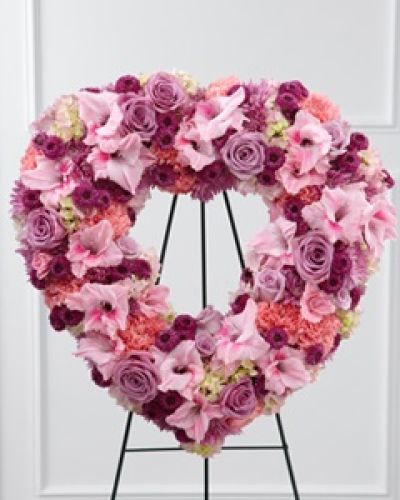 <p data-start="139" data-end="488">When words fall short, express your deepest sympathies with <em data-start="272" data-end="311">The FTD® Eternal Rest™ Standing Heart</em>. This breathtaking floral tribute is crafted to honor a cherished life with warmth, affection, and timeless beauty, offering comfort to grieving hearts during a final farewell.</p>
<p data-start="490" data-end="936">Shaped as an open heart, this standing arrangement is filled with an elegant mix of lavender and pink blooms that symbolize admiration, grace, and love. The gentle hue of lavender roses conveys reverence, while pink carnations offer sweetness and remembrance. Lavender chrysanthemums, purple button poms, and pink gladiolus add texture and dimension, all delicately balanced by soft pink hydrangea that brings fullness and serenity to the design.</p>
<p data-start="938" data-end="1261">Expertly arranged by our local florists, each flower is carefully selected for its color, meaning, and freshness to ensure a touching and respectful tribute. Displayed on a sturdy wire easel, this piece stands tall at the memorial or funeral service, serving as a beautiful expression of the love that lives on beyond loss.</p>
<p data-start="1263" data-end="1559"><em data-start="1263" data-end="1297">The Eternal Rest™ Standing Heart</em> is ideal for honoring mothers, grandmothers, daughters, or anyone whose gentle spirit and loving presence deserve to be remembered with elegance. It’s a comforting reminder of how deeply they were loved and how warmly they’ll be remembered by all who knew them.</p>
<p data-start="1561" data-end="1822">Rosa’s La Hacienda offers hand delivery across Boca Raton, ensuring this heartfelt gift arrives on time and in perfect condition. Whether it’s delivered to a funeral home, house of worship, or family home, our team handles every detail with care and compassion.</p>
<p data-start="1824" data-end="2030">Let <em data-start="1828" data-end="1867">The FTD® Eternal Rest™ Standing Heart</em> reflect the enduring love and grace of the one you’ve lost. It’s more than a floral display—it’s a symbol of lasting devotion and a meaningful way to say goodbye.</p>