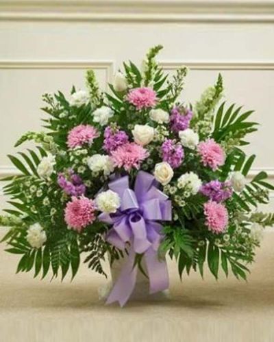 <p data-start="234" data-end="496">Offer a graceful expression of remembrance with a floral tribute that blends beauty, serenity, and heartfelt support. The <em data-start="356" data-end="406">Touching Tribute Floor Basket – Lavender & White</em> is a tender way to honor a loved one and share your sympathy with those who are grieving.</p>
<p data-start="498" data-end="784">This elegant arrangement features a soft mix of white roses, snapdragons, and carnations, paired with soothing lavender mums, lavender stock, and additional seasonal accents. Hand-arranged in a traditional floor basket, the design balances purity and peace with gentle color and warmth.</p>
<p data-start="786" data-end="1113">The lavender blooms represent dignity, grace, and a life well lived, while the white flowers symbolize reverence and eternal peace. Suitable for sending directly to the funeral home, this tribute is appropriate for family, friends, or business associates wishing to express their condolences in a respectful and meaningful way.</p>
<p data-start="1115" data-end="1397">Each <em data-start="1120" data-end="1170">Touching Tribute Floor Basket – Lavender & White</em> is carefully handcrafted by the expert florists at Rosa’s La Hacienda, your trusted local florist in Boca Raton. We offer same-day delivery to funeral homes and service venues throughout Boca Raton and surrounding communities.</p>
<p data-start="1399" data-end="1585">Add a thoughtful message at checkout to accompany your tribute. With its calming colors and elegant design, this basket serves as a comforting reminder of love, support, and remembrance.</p>