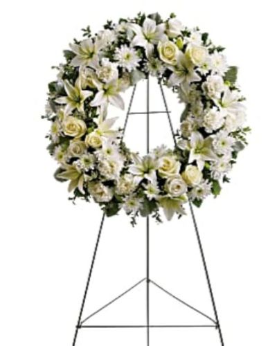 <div id="mark-1" class="m-pdp-tabs-marketing-description">
<p data-start="60" data-end="414">Honor the gentle spirit of a loved one with the <em data-start="108" data-end="125">Serenity Wreath</em>, a timeless symbol of eternal love and remembrance. Composed of soft white blossoms and soothing greenery, this standing wreath offers comfort and calm during times of sorrow. It is a thoughtful expression of sympathy, perfectly suited for funeral services, wakes, or memorial gatherings.</p>
<p data-start="416" data-end="825">This elegant wreath features a harmonious blend of white roses, asiatic lilies, carnations, and chrysanthemums—each chosen for their symbolic purity, love, and reverence. The floral ring is accented with lush greens including salal, oregonia, and dusty miller, adding texture and natural beauty to the design. Mounted on a wire easel, the arrangement stands tall and dignified as a focal point of remembrance.</p>
<p data-start="827" data-end="1070">The circular shape of the <em data-start="853" data-end="870">Serenity Wreath</em> represents eternity and the continuity of love, making it a meaningful tribute for honoring a parent, grandparent, or dear friend whose memory will forever remain in the hearts of those they touched.</p>
<p data-start="1072" data-end="1345">Each wreath is handcrafted with care by the expert florists at Rosa’s La Hacienda in Boca Raton. We provide same-day delivery to funeral homes and memorial venues across Boca Raton and surrounding communities, ensuring your tribute arrives fresh and respectfully presented.</p>
<p data-start="1347" data-end="1585">Include a personal message at checkout to share your thoughts, love, or condolences. At Rosa’s La Hacienda, we are honored to help you express your sympathies through flowers that offer comfort and reflect the beauty of a life remembered.</p>
<p data-start="1587" data-end="1728" data-is-last-node="" data-is-only-node="">Order today for same-day delivery in Boca Raton and nearby areas. <em data-start="1653" data-end="1670">Serenity Wreath</em> is a graceful expression of love, peace, and remembrance.</p>
</div>