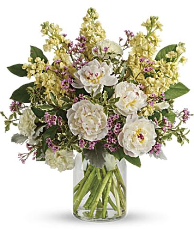 <p>Some moments ask for gentleness, and this bouquet answers with quiet grace. With its soft tones and soothing presence, it offers a peaceful expression of love, care, or remembrance. Whether given to celebrate, comfort, or simply brighten a day, this arrangement brings a subtle kind of beauty that speaks directly to the heart.</p>
<p>At the heart of the bouquet are cloud-like white peonies, their lush petals opening with a sense of quiet grandeur. They are joined by pale yellow carnations, buttery-hued stock, and sprigs of lavender waxflower for a hint of color and texture. Silvery dusty miller and glossy lemon leaf frame the blooms, all arranged in a clear milk jug-style vase that balances rustic charm with refined elegance.</p>
<p>This serene design makes a meaningful gift for spring gatherings, Easter celebrations, sympathy occasions, baby showers, or any moment that calls for calm and beauty. Its understated palette and natural flow make it just as fitting for a kitchen table as it is for a formal setting.</p>
<p>Every bouquet is carefully arranged and hand-delivered by a skilled local florist, using the freshest flowers available. Because each season brings its own variety, substitutions may be made to preserve the bouquet’s tranquil look and feel. Some flowers may arrive in bud form, giving the recipient the joy of watching them blossom.</p>
<p>Send a quiet message of love, hope, or renewal with a bouquet that radiates softness and intention—an elegant reminder that even in stillness, beauty blooms.</p>