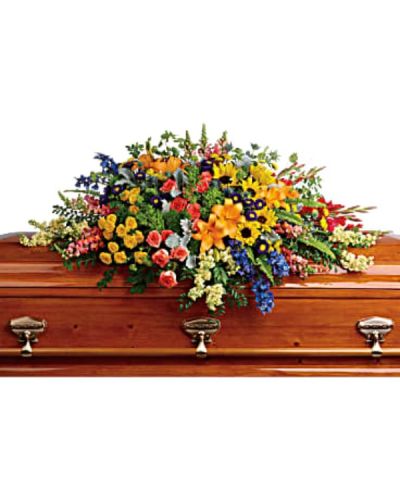 <div id="mark-1" class="m-pdp-tabs-marketing-description">
<p data-start="80" data-end="513">Celebrate the spirit of someone who brought joy, light, and color to the world with the Colorful Reflections Casket Spray. This vivid and uplifting floral display is designed to honor a vibrant personality and offer a rainbow of hope and comfort to those in mourning. Filled with rich textures and a full spectrum of hues, it serves as a striking tribute that reflects a life filled with warmth, laughter, and unforgettable memories.</p>
<p data-start="515" data-end="1160">This expertly crafted casket spray overflows with an array of fresh, seasonal blooms. Green hydrangea creates a lush foundation, accented by orange roses, yellow spray roses, and large golden sunflowers that radiate brightness and cheer. Red gladioli and orange snapdragons add height and energy, while blue delphinium and blue eryngium bring cool contrast and serenity. Light yellow stock and purple matsumoto asters introduce softness, with yellow button spray chrysanthemums and green trick dianthus lending playful texture. The entire design is completed with bupleurum, dusty miller, and rich greenery for a natural, garden-inspired finish.</p>
<p data-start="1162" data-end="1490">Perfect for funeral services, celebrations of life, or memorial gatherings, this arrangement speaks to the beauty and vibrancy of the person being remembered. Each flower was chosen to represent elements of joy, strength, peace, and remembrance, creating a balanced tribute that brings both color and comfort to a solemn moment.</p>
<p data-start="1492" data-end="1870">The Colorful Reflections Casket Spray is handcrafted by the compassionate florists at Rosa’s La Hacienda in Boca Raton. We offer same-day delivery to local funeral homes, places of worship, and private residences, ensuring your flowers arrive fresh and beautifully arranged with attention to every detail. Our team is here to help you honor your loved one with care and respect.</p>
<p data-start="1872" data-end="2081">Include a personal note of condolence at checkout to accompany this meaningful tribute. Rosa’s La Hacienda is proud to support families during life’s most tender moments with flowers that speak from the heart.</p>
<p data-start="2083" data-end="2161" data-is-last-node="" data-is-only-node="">Same-day delivery available throughout Boca Raton and surrounding communities.</p>
</div>