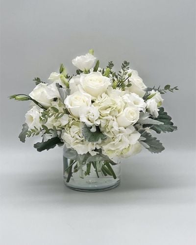 <p data-start="120" data-end="460">Make a lasting impression with White Dreams, a stunning all-white bouquet that exudes elegance, purity, and calm. Perfect for life's most meaningful moments, this arrangement is a sophisticated way to express love, sympathy, appreciation, or simply a thoughtful “thinking of you.”</p>
<p data-start="462" data-end="777">This bouquet features a radiant mix of fresh white blooms—such as roses, lilies, hydrangeas, or spray chrysanthemums—each selected for its beauty and serene presence. Accented with soft greenery and arranged in a classic glass vase, the composition offers a clean, polished look that feels both modern and timeless.</p>
<p data-start="779" data-end="997">White Dreams is an ideal gift for weddings, anniversaries, sympathy tributes, or to celebrate new beginnings. The neutral color palette brings light and peace to any setting, making it a versatile and heartfelt choice.</p>
<p data-start="999" data-end="1279">Every arrangement is handcrafted by the floral designers at Rosa’s La Hacienda, your trusted flower shop in Boca Raton. We offer same-day flower delivery throughout Boca Raton and surrounding neighborhoods, ensuring your bouquet arrives fresh, fragrant, and beautifully presented.</p>
<p data-start="1281" data-end="1522">Want to make your gift even more personal? Add a custom message during checkout to share your thoughts alongside this graceful arrangement. With White Dreams, you're sending more than flowers—you’re sending a gesture of sincerity and warmth.</p>
<p data-start="1524" data-end="1613">Order now from Rosa’s La Hacienda and let the quiet beauty of white blooms speak for you.</p>