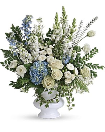 <p data-start="127" data-end="474">Honor the memory of someone dearly loved with Treasured Beloved, a serene and elegant bouquet that brings together soft blue and pure white blooms. This exquisite arrangement offers a message of peace, remembrance, and enduring love, beautifully presented in a graceful white urn.</p>
<p data-start="476" data-end="835">The bouquet features light blue hydrangea, white roses, white spray roses, white lisianthus, light blue delphinium, white snapdragons, white stock, and white waxflower. Accents of huckleberry, variegated ivy, spiral eucalyptus, dagger fern, and lemon leaf add texture and natural depth, creating a full and balanced design that reflects both beauty and grace.</p>
<p data-start="837" data-end="1096">Delivered in a white designer urn, Treasured Beloved is a thoughtful choice for memorial services, funerals, or to send directly to the family. Its soft hues and gentle form offer a sense of calm and hope, serving as a meaningful tribute to a life well lived.</p>
<p data-start="1098" data-end="1382">Each arrangement is handcrafted with care by the team at Rosa’s La Hacienda, your trusted florist in Boca Raton. We provide same-day flower delivery throughout Boca Raton and surrounding communities, ensuring each bouquet is prepared locally and delivered with respect and compassion.</p>
<p data-start="1384" data-end="1603">Want to include a message of sympathy? Add your words at checkout to personalize this heartfelt tribute. With Treasured Beloved, you're sending more than flowers—you’re offering comfort, love, and a lasting remembrance.</p>
<p data-start="1605" data-end="1689">Order today from Rosa’s La Hacienda and honor someone special with beauty and grace.</p>