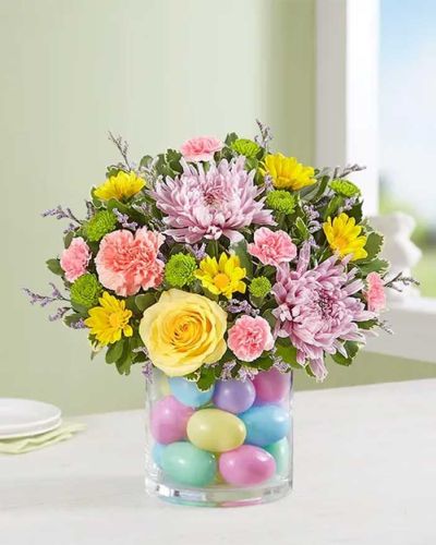 <p data-start="205" data-end="547">Brighten your Easter with a bouquet that’s as delightful as the holiday itself. The <em data-start="289" data-end="314">Easter Egg-Stravaganza™</em> is a pastel-colored celebration of everything fresh, cheerful, and full of life. Whether you’re hosting a family brunch or sending love across the miles, this arrangement brings warmth, happiness, and seasonal beauty to any setting.</p>
<p data-start="549" data-end="920">A soft and harmonious blend of spring’s best blooms takes center stage in this bouquet. Picture pink and yellow roses, lavender daisies, pale alstroemeria, and delicate carnations—all working together like a watercolor painting come to life. Accents of seasonal greenery provide contrast and freshness, making the colors pop while keeping the overall look light and airy.</p>
<p data-start="922" data-end="1289">Arranged in a clear glass cylinder vase, this bouquet is designed for versatility and elegance. It looks just as perfect gracing a family dining table as it does sitting by a sunny kitchen window or welcoming guests in the entryway. The vase’s clean lines offer a timeless presentation, allowing the flowers to shine while fitting effortlessly into your spring décor.</p>
<p data-start="1291" data-end="1601">This cheerful bouquet is a lovely gift for family, friends, neighbors, or even yourself. It’s especially well-suited for Easter Sunday, spring birthdays, baby showers, or simply celebrating the season’s renewal. The soft palette and joyful style make it appropriate for both personal and professional settings.</p>
<p data-start="1603" data-end="1971">Hand-delivered by Rosa’s La Hacienda in Boca Raton, this Easter bouquet arrives fresh and arranged with care by local florists. Due to seasonal availability, some flower varieties may vary, but rest assured your bouquet will always reflect the soft pastel palette and radiant spirit of spring. Each delivery is a joyful surprise designed to create smiles and memories.</p>
<p data-start="1973" data-end="2106">Celebrate Easter with the gentle beauty of the <em data-start="2020" data-end="2045">Easter Egg-Stravaganza™</em>—a springtime bouquet that brings happiness with every petal.</p>