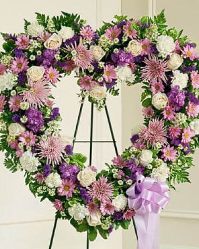 <p data-start="155" data-end="479">Honor a life filled with love and kindness with the Forever Cherished Floral Heart Tribute – Lavender. Thoughtfully designed for moments of remembrance, this heart-shaped standing spray offers a graceful expression of sympathy and the love that lives on in your heart.</p>
<p data-start="481" data-end="802">Delicately arranged with soft lavender and white blooms, this tribute symbolizes peace, memory, and gentle strength. Each floral heart is handcrafted by our expert florists using a thoughtful selection of roses, carnations, mums, and seasonal accents, creating a design that is both comforting and beautifully respectful.</p>
<p data-start="804" data-end="1069">Traditionally sent directly to the funeral home by close friends or family, this standing spray is a meaningful way to celebrate a loved one’s life during memorial services and viewings. Its soft color palette brings a sense of calm and reflection to any gathering.</p>
<p data-start="1071" data-end="1328">Every tribute is created with care by Rosa’s La Hacienda, your trusted local florist in Boca Raton. We offer timely, respectful delivery to funeral homes across Boca Raton and surrounding areas, ensuring each arrangement is presented with grace and dignity.</p>
<p data-start="1330" data-end="1582">Want to include a personal message of condolence? Add a note during checkout to share your heartfelt words. With the Forever Cherished Floral Heart – Lavender, you're sending more than sympathy—you’re honoring a beautiful life with love and compassion.</p>
<p data-start="1584" data-end="1675">Order today from Rosa’s La Hacienda and let your tribute speak with elegance and sincerity.</p>