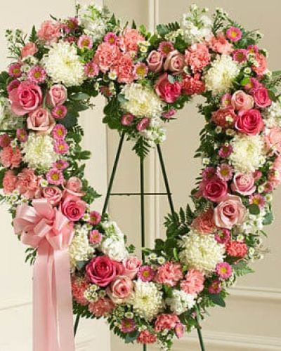 <p>Commemorate them and the special place they will always hold in your heart with this heart-shaped floral arrangement. Crafted by our expert florists using fresh pink and white flowers including roses, stock, carnations and more, it's a beautiful way to send your deepest condolences to family, friends or any special person in your life. Traditionally sent directly to the funeral home by family members or friends and displayed on a stand.</p>