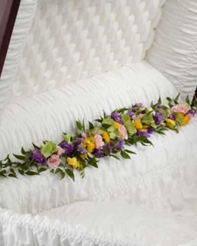 <p data-start="163" data-end="486">Soft and graceful, The FTD® Trail of Flowers™ Casket Adornment offers a delicate way to express love and honor at a final farewell. Designed to rest along the inside of the casket, this thoughtful accent brings warmth and serenity to the service.</p>
<p data-start="488" data-end="949">The arrangement features a harmonious blend of colors and textures, combining the freshness of green hydrangea with the soft charm of pink spray roses. Bright yellow freesia adds a touch of cheer and fragrance, while lavender larkspur and yellow button poms provide vertical interest and a nod to nature’s gentle beauty. The mix is expertly arranged to cascade in a natural line, evoking the image of a trail of blooms leading from this life into peaceful rest.</p>
<p data-start="951" data-end="1319">This piece is more than a floral arrangement—it’s a symbolic pathway of love, guiding the memory of your loved one with softness, elegance, and light. Each flower in the adornment represents qualities such as devotion, joy, and peaceful remembrance, making this design especially fitting for someone who walked gently through life and left beauty behind in their path.</p>
<p data-start="1321" data-end="1636">Perfect as an added expression to complement larger sprays or standing pieces, the Trail of Flowers™ is ideal for families who want every detail of the service to reflect love and care. Whether honoring a parent, grandparent, spouse, or dear friend, this adornment offers a tender final gesture of beauty and grace.</p>
<p data-start="1638" data-end="1911">Arranged and delivered with the utmost care by Rosa’s La Hacienda in Boca Raton, this casket adornment ensures a seamless and heartfelt presentation. As a local florist known for quality and compassion, we make sure each flower arrives fresh, vibrant, and perfectly placed.</p>
<p data-start="1913" data-end="2028">Let this path of blossoms serve as a final tribute—a gentle reminder that love continues to bloom, even in goodbye.</p>