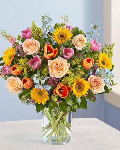<p>Capture the essence of spring with a bouquet that feels like a walk through a blooming garden. Overflowing with color, fragrance, and charm, this luxurious arrangement celebrates everything that makes the season so beloved—renewal, warmth, and the quiet joy of fresh flowers shared with someone special.</p>
<p>A curated mix of seasonal blooms creates a harmonious display of blush pinks, sky blues, lemony yellows, and soft peach tones. Depending on availability, flowers may include roses, hydrangeas, carnations, lilies, delphinium, or stock. Each stem is hand-selected for its texture and hue, blending into a vibrant yet elegant composition.</p>
<p>Designed for visual impact, this bouquet brings garden-fresh beauty indoors. Its full, flowing shape and fragrant blooms instantly brighten any space, making it an ideal gift for birthdays, thank-you moments, get-well wishes, or simply sharing a splash of springtime color. It creates a warm and uplifting atmosphere wherever it’s placed.</p>
<p>Whether you’re celebrating a seasonal holiday, sending a meaningful surprise, or treating yourself to something beautiful, this bouquet delivers a touch of nature’s finest. Its cheerful palette and abundant style are especially fitting for Easter, Mother’s Day, or any occasion that calls for something truly memorable.</p>
<p>Each bouquet is handcrafted and delivered with care by an experienced florist. Flower types and stages may vary slightly due to seasonal availability, but the spirit of the arrangement remains consistent—fresh, joyful, and full of life. Let the beauty of spring bloom indoors with a gift that’s as radiant and heartfelt as the season itself.</p>