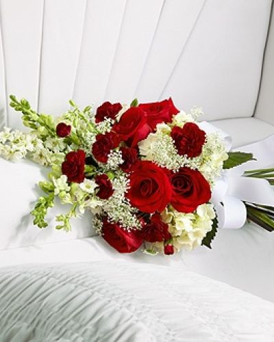<p data-start="167" data-end="550">Honor your loved one with a final gesture of beauty and elegance through The FTD® Forever in Our Hearts™ Casket Adornment. This delicate floral arrangement is designed to rest gently on the casket, adding a refined accent to the service while expressing heartfelt love and remembrance.</p>
<p data-start="552" data-end="1015">Featuring vivid red roses and miniature red carnations, this arrangement offers a striking contrast to the soft white hydrangea, larkspur, snapdragons, and Queen Anne’s Lace. The blend of bold and gentle tones reflects the complexity of love and loss—passion, admiration, and peace all expressed in one beautiful composition. A white grosgrain ribbon ties the bouquet together, symbolizing unity, purity, and the lasting bond you hold with the one who has passed.</p>
<p data-start="1017" data-end="1281">This casket adornment is ideal for adding a personal, meaningful touch to a larger floral display or for those who prefer a more subtle tribute. It complements full casket sprays and standing arrangements while standing beautifully on its own as a gentle farewell.</p>
<p data-start="1283" data-end="1640">Every arrangement is handcrafted by Rosa’s La Hacienda in Boca Raton. We prepare each order with care, attention to detail, and sensitivity to the occasion. We also coordinate directly with funeral homes and service venues to ensure seamless, respectful delivery and presentation. Same-day delivery is available throughout Boca Raton and nearby communities.</p>
<p data-start="1642" data-end="1835">Want to include a personal message with your floral tribute? Add your note during checkout and we will ensure it accompanies the arrangement with the dignity and compassion the moment deserves.</p>
<p data-start="1837" data-end="1993">Order The FTD® Forever in Our Hearts™ Casket Adornment today from Rosa’s La Hacienda and let us help you say goodbye with beauty, grace, and heartfelt care.</p>